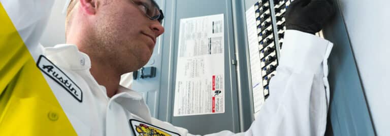 Electrician servicing panel, Electrical Safety Audit.