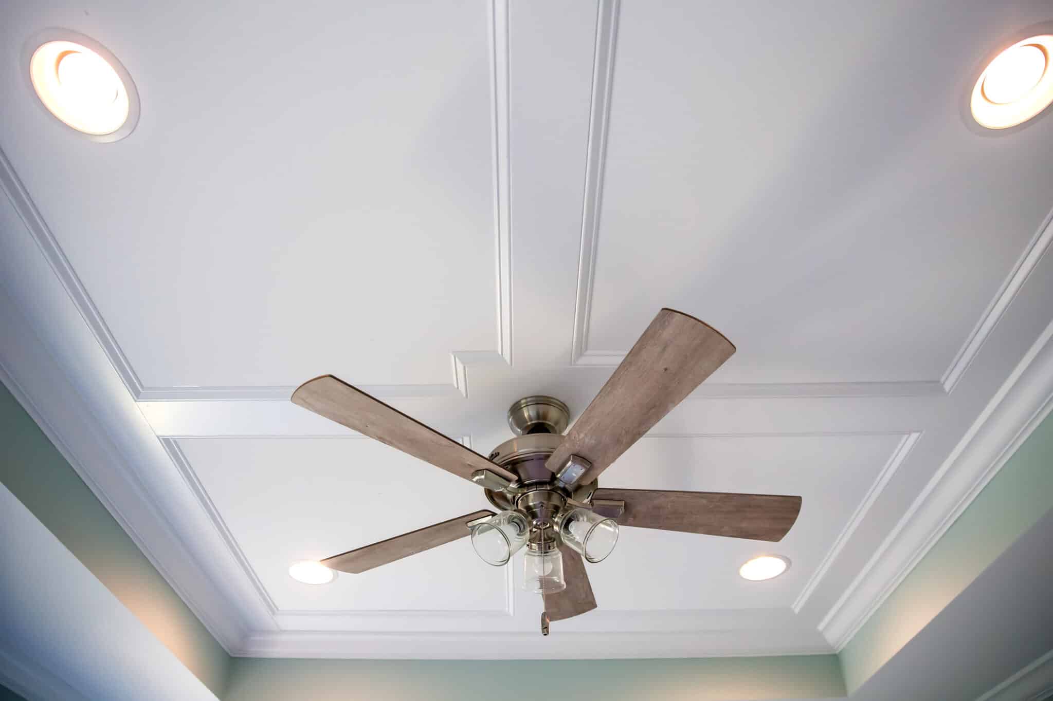 White tray ceiling in small new construction house with windows and a ceiling fan, Ceiling Fan Installation.