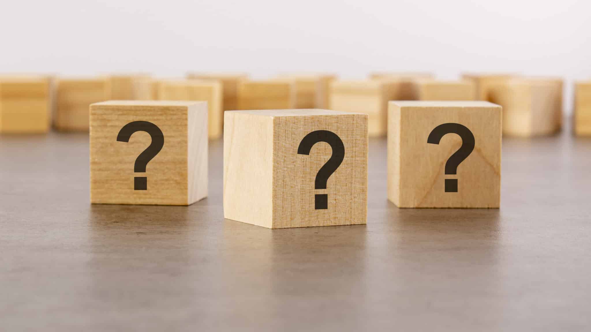 Cube with question mark on wooden background, Indoor Lighting Design.