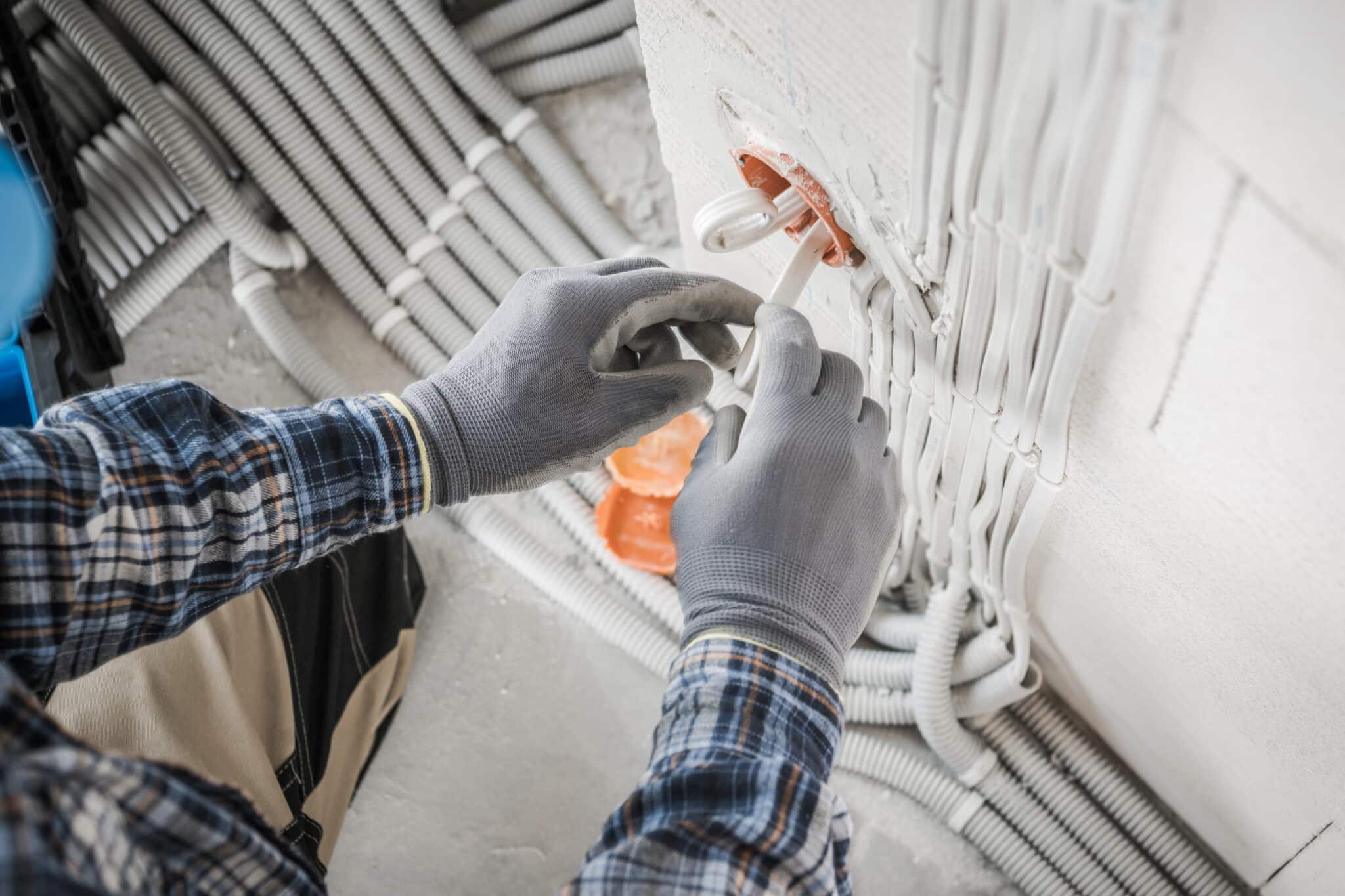 Electrician installing power socket, Electrical Contractor.