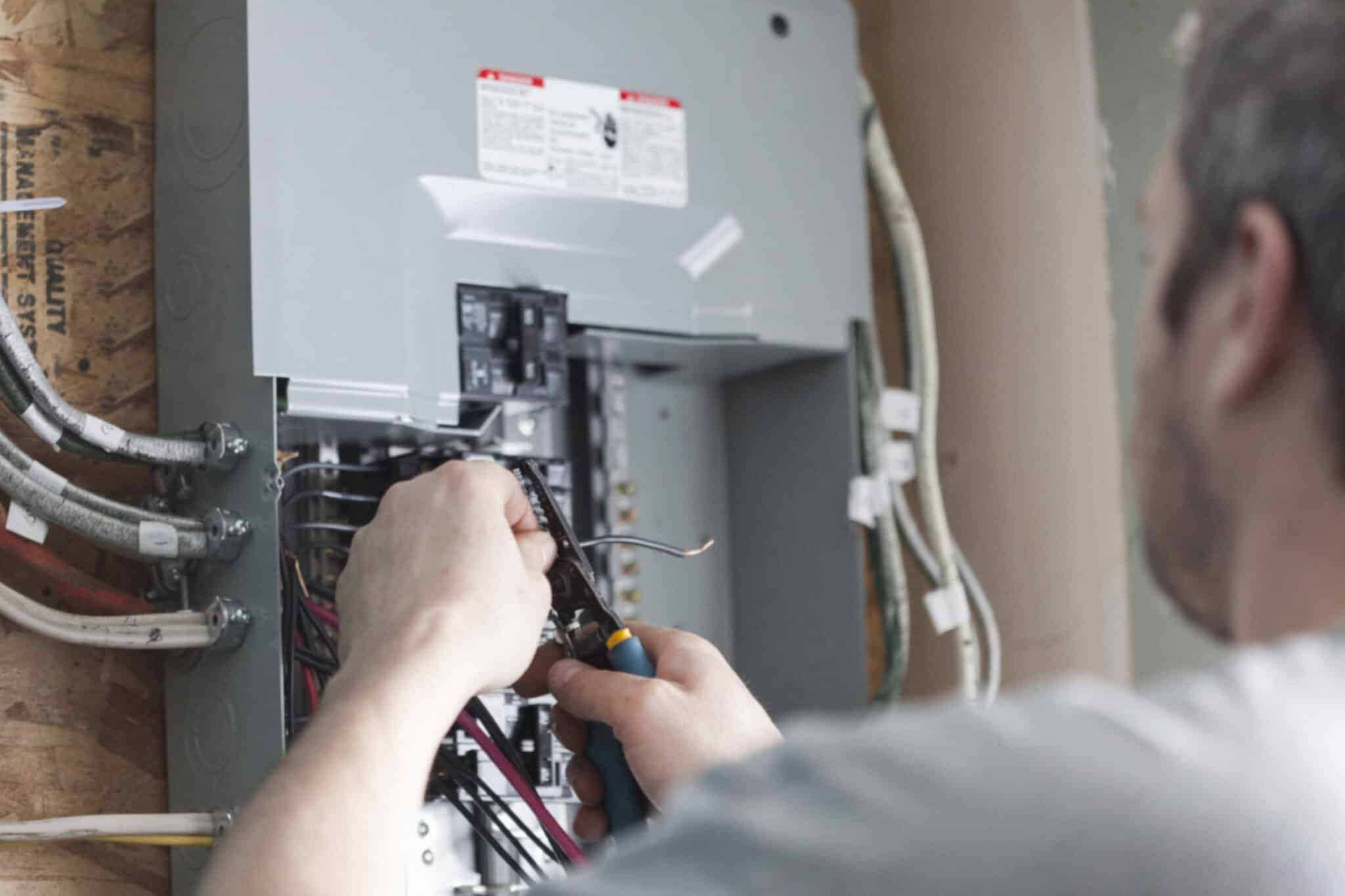 Electrician replacing the distribution board to upgrade a homes electrical panel, Smart Electrical Panels.